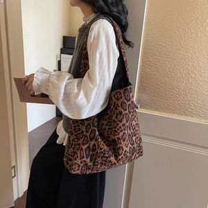 Leopard print large capacity tote bag shown on model in a minimalist lifestyle setting
