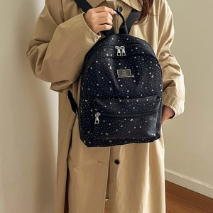 Minimalist black backpack with white star print and metallic zipper for women's winter fashion
