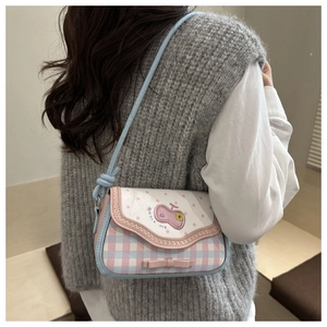 Detail shot of the cute apple-style handbag featuring plaid patterns and bow embroidery