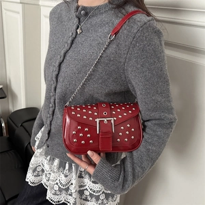 Red patent leather punk shoulder bag with silver studs and metal buckle detail