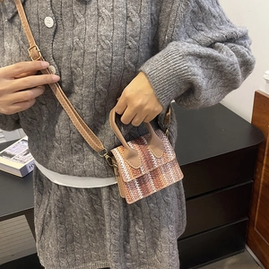 Mini crossbody bag with brown and orange woven stripes, top handle and leather strap