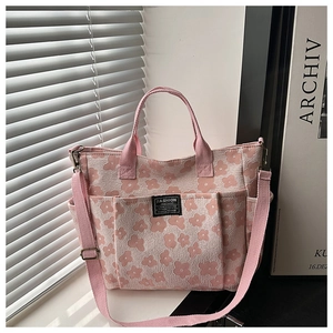 Detail of pink floral canvas tote with multi-pockets and adjustable shoulder strap