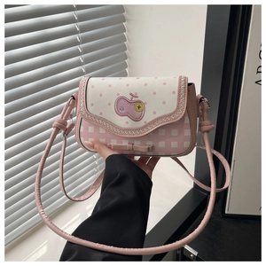 Close-up of pink and white checkered crossbody bag with cherry embroidery and bow