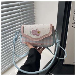 Macro detail of macaron-colored crossbody bag featuring cherry motifs and bow details
