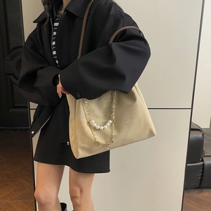 Minimalist beige tote bag with pearl gold chain and leather shoulder strap for women
