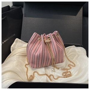 Pink and black tweed bucket bag with gold chain and pearl tassels in a gift box