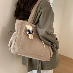 Chic khaki corduroy tote bag for women featuring a cute teddy bear pendant detail