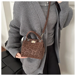 Detailed view of brown leopard print crossbody bag with metal lock and suede texture