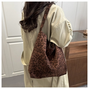 Detail of leopard print tote bag showing thick canvas texture and sturdy shoulder strap