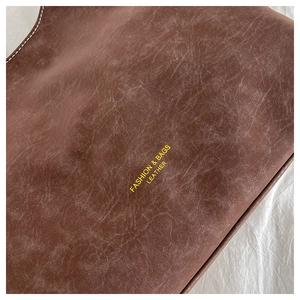 Detailed macro view of vintage brown leather texture with fashion and bags print