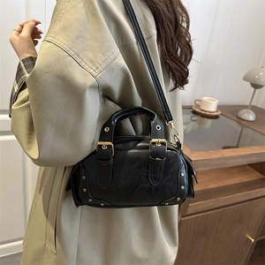 Retro black leather bowling bag with gold studs shown as shoulder and crossbody style