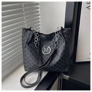 Detail of grey tote bag with M-letter jacquard, silver chain strap, and metal logo