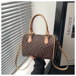 Detail of Boston bag showing geometric pattern, double handles and red edge paint finish