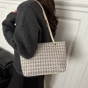 Luxurious plaid tweed chain crossbody bag with woven pattern shown on a model