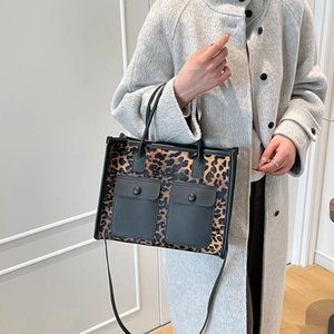 Stylish leopard print tote bag with black pockets and shoulder strap for women