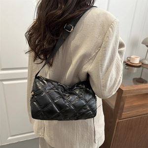 Quilted black nylon crossbody bag with adjustable strap and shiny finish for women