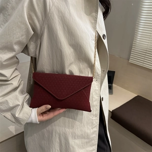 Minimalist burgundy envelope crossbody bag with V-shaped flap and gold chain strap