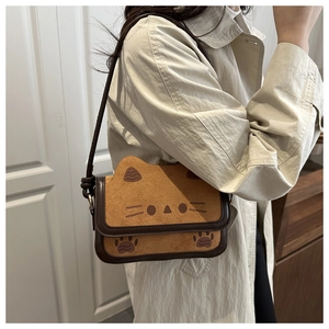 Detail of camel suede cat shoulder bag with leather knotted strap and paw prints