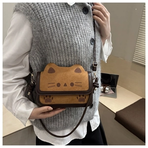 Side view of a brown cat-shaped crossbody bag with cute ear details and adjustable strap