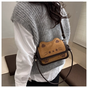 Detail of cute brown cat-shaped crossbody bag with soft faux fur and 3D ears on model