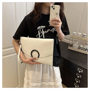 Chic off-white envelope clutch bag featuring a black U-shaped buckle and wrist strap