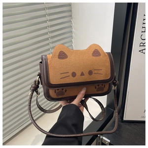 Detail of cute cat shaped brown crossbody bag with embroidered whiskers and 3D ears