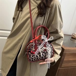 Leopard print Boston handbag with red leather straps and cherry charm decoration