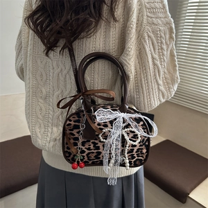 Chic leopard print crossbody bag with cherry charm and pearl tassel details