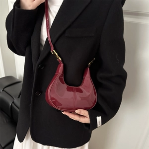 Minimalist wine red patent leather crescent shoulder bag with golden metallic buckle