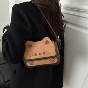 Cute cat-shaped crossbody bag in tan faux suede with brown trim and shoulder strap