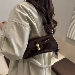 Minimalist chocolate brown patent leather baguette shoulder bag with gold metal buckle