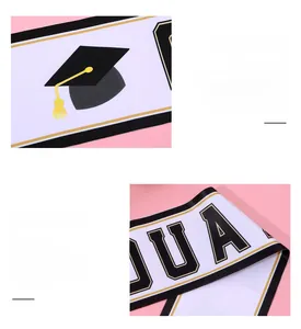 Detail of white satin graduation sash with black trim and gold foil graduate lettering