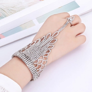 Detailed close-up of a silver rhinestone slave bracelet with intricate wavy hollow patterns