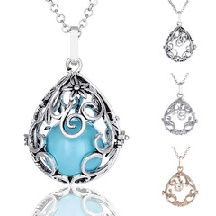 Close-up of teardrop hollow pendant necklace with interchangeable colorful inner beads