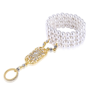 Detailed macro of vintage style multi-layer pearl hand chain with gold rhinestone accents