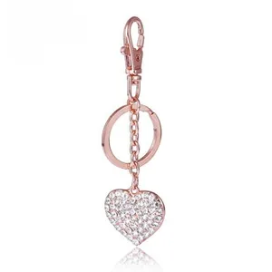 Close-up of heart-shaped keychain with white rhinestones and rose gold plating finish