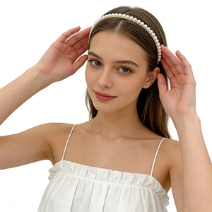 Elegant gold bridal headband with white pearls on a minimalist metal base for women