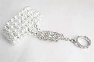 Detailed view of multilayer pearl hand chain with sparkling crystal embellishments