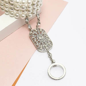 Close-up of bohemian silver slave bracelet with four-row pearls and crystal ring