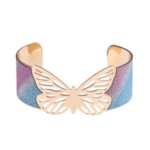 Golden open butterfly bangle with purple and blue glitter wings on white background