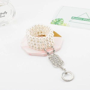 Detail of elegant bridal slave bracelet with five rows of pearls and floral rhinestone patterns