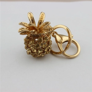 Detail of golden pineapple keychain with yellow crystals and lobster clasp hook