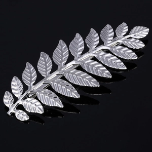 Silver baroque leaf hair clip with detailed fern texture on a reflective black background