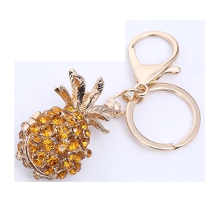 Golden pineapple keychain with sparkling yellow crystals and leaf detail for bags