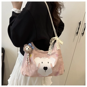 Detailed view of pink canvas tote bag with lace-trimmed straps and plush toy charm accessory