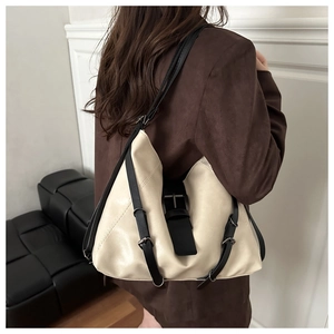 Detailed view of the ivory leather hobo tote bag with black contrast shoulder straps