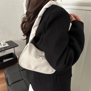 Retro pleated underarm bag in white PU leather featuring a black metal bow decoration