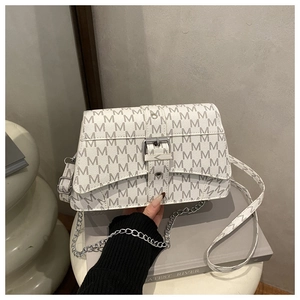 Detail of white crossbody bag featuring grey M letter print and silver metal buckle