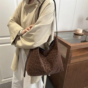 Vintage leopard print hobo shoulder bag in brown suede styled with a casual trench coat