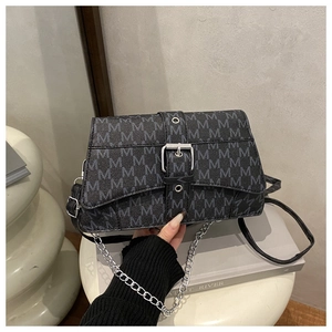 Detail of silver chain strap and gray M-pattern monogram on a chic crossbody bag